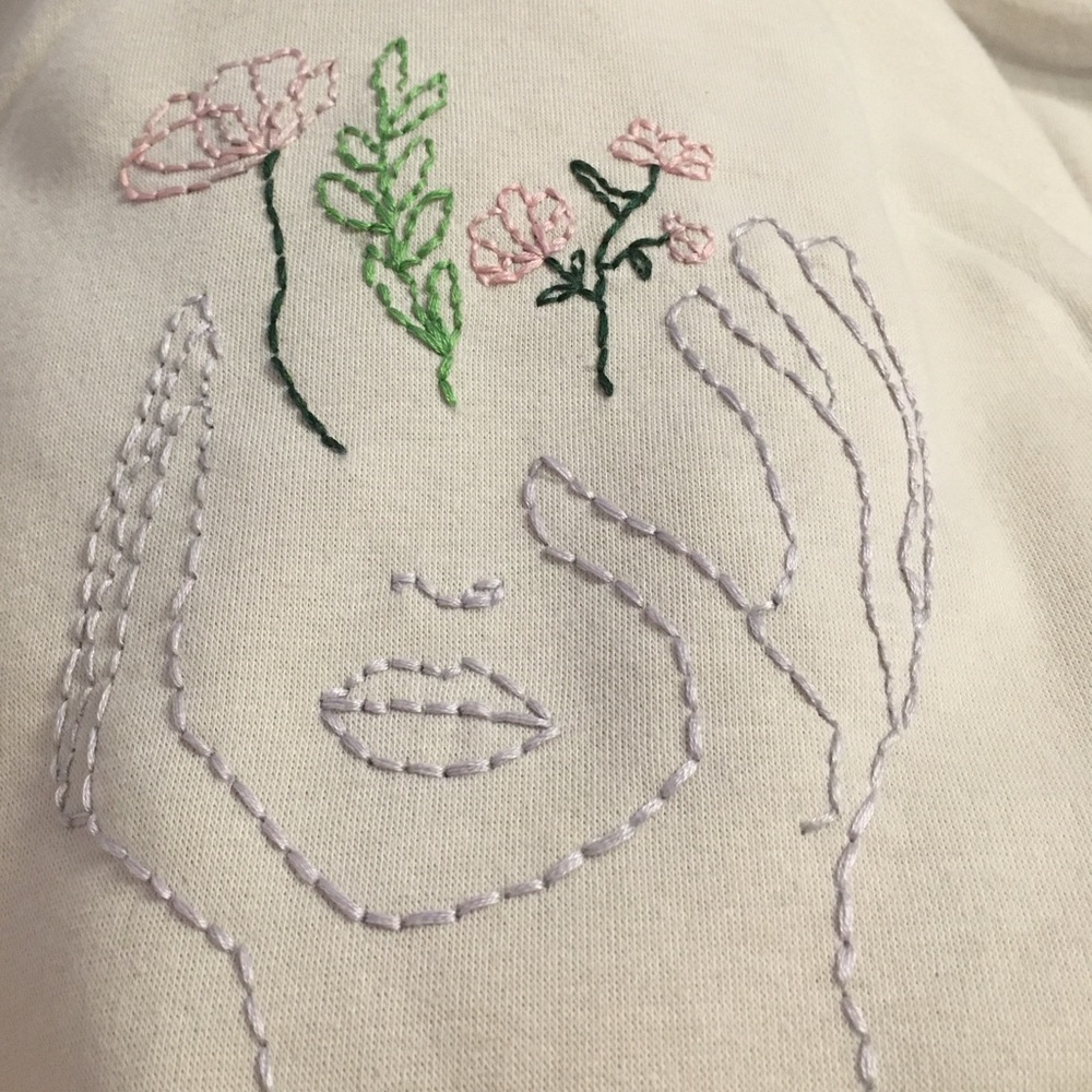 Embroidered face/flowers sweatshirts